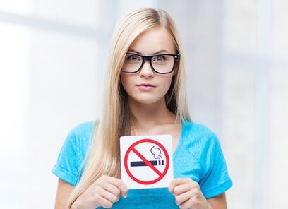 girl holding a no smoking sign at the entrance
